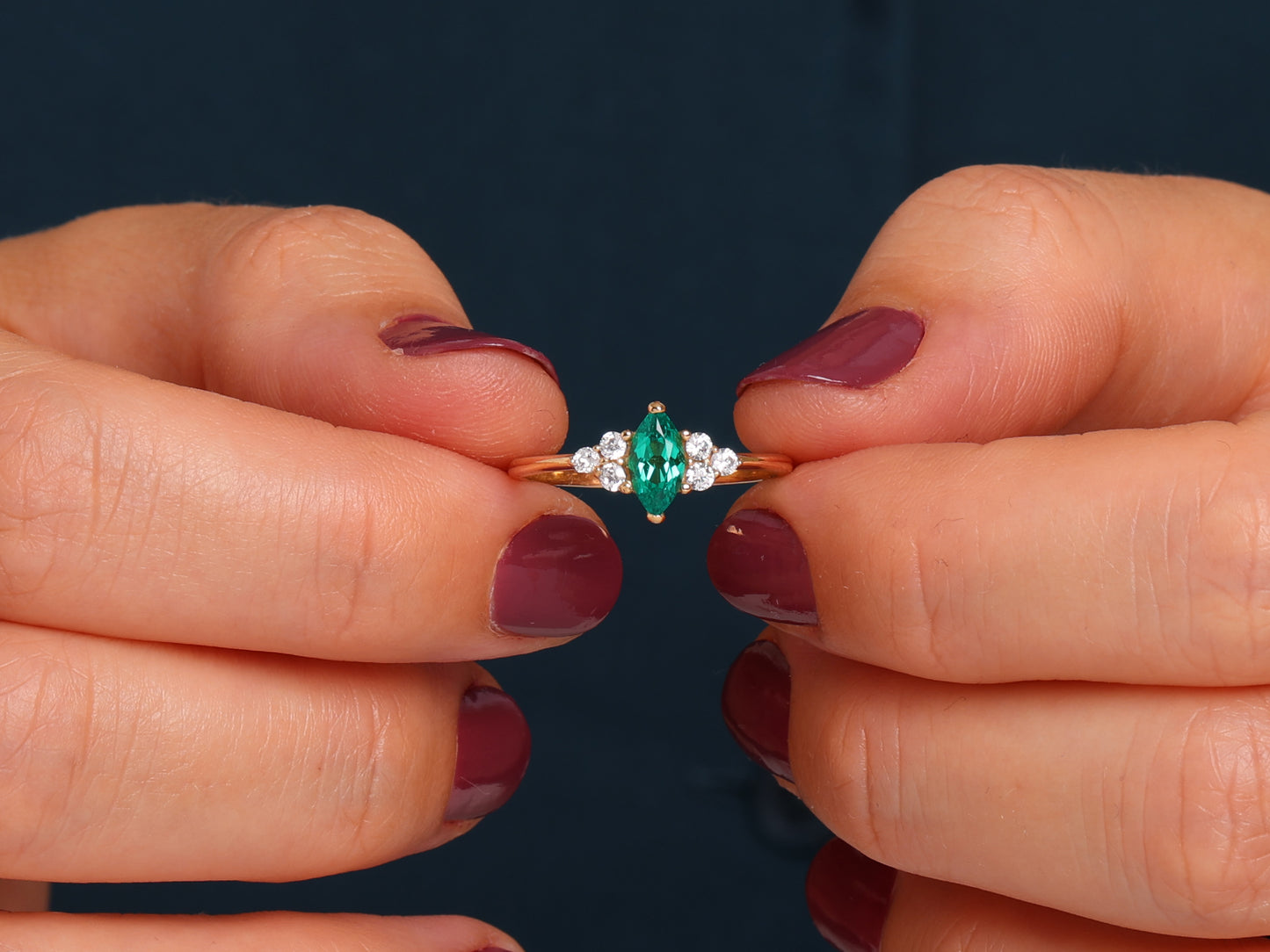 RUBY MARQUISE RING WITH ROUND DIAMONDS IN GOLD