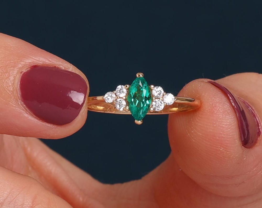 RUBY MARQUISE RING WITH ROUND DIAMONDS IN GOLD
